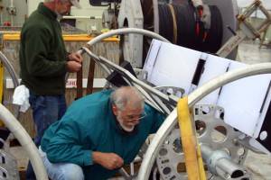 Jim Valdes and Will Ostrom spend the day getting the mooring ready. Here, they are loading a float into a SALP rosette. Enlarge Image Jim Valdes and Will Ostrom spend the day getting the mooring ready. Here, they are loading a float into a SALP rosette. (Photo by David Sutherland, Woods Hole Oceanographic Institution)