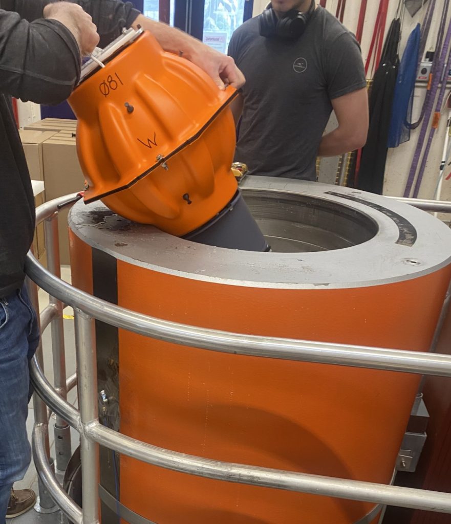 Photo of someone putting a RAFOS float into the Pressure Tank.